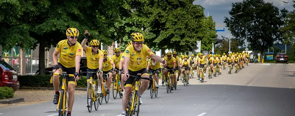 Cyklister i gula tröjor från Team Rynkeby